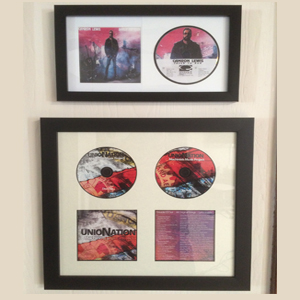 Two framed records are hanging on the wall.